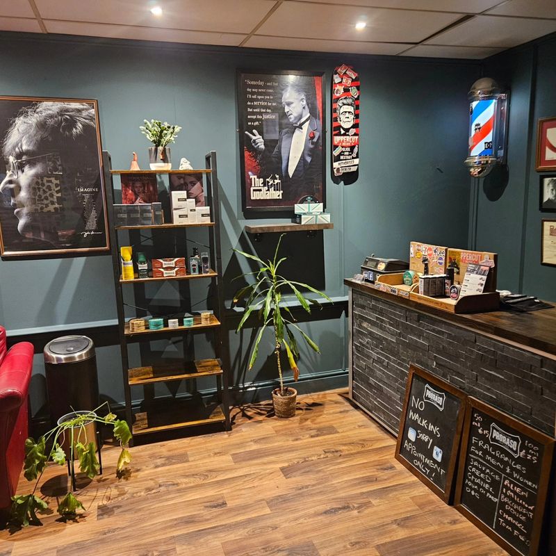 Inside Dean's: green walls, the chair and the barber pole