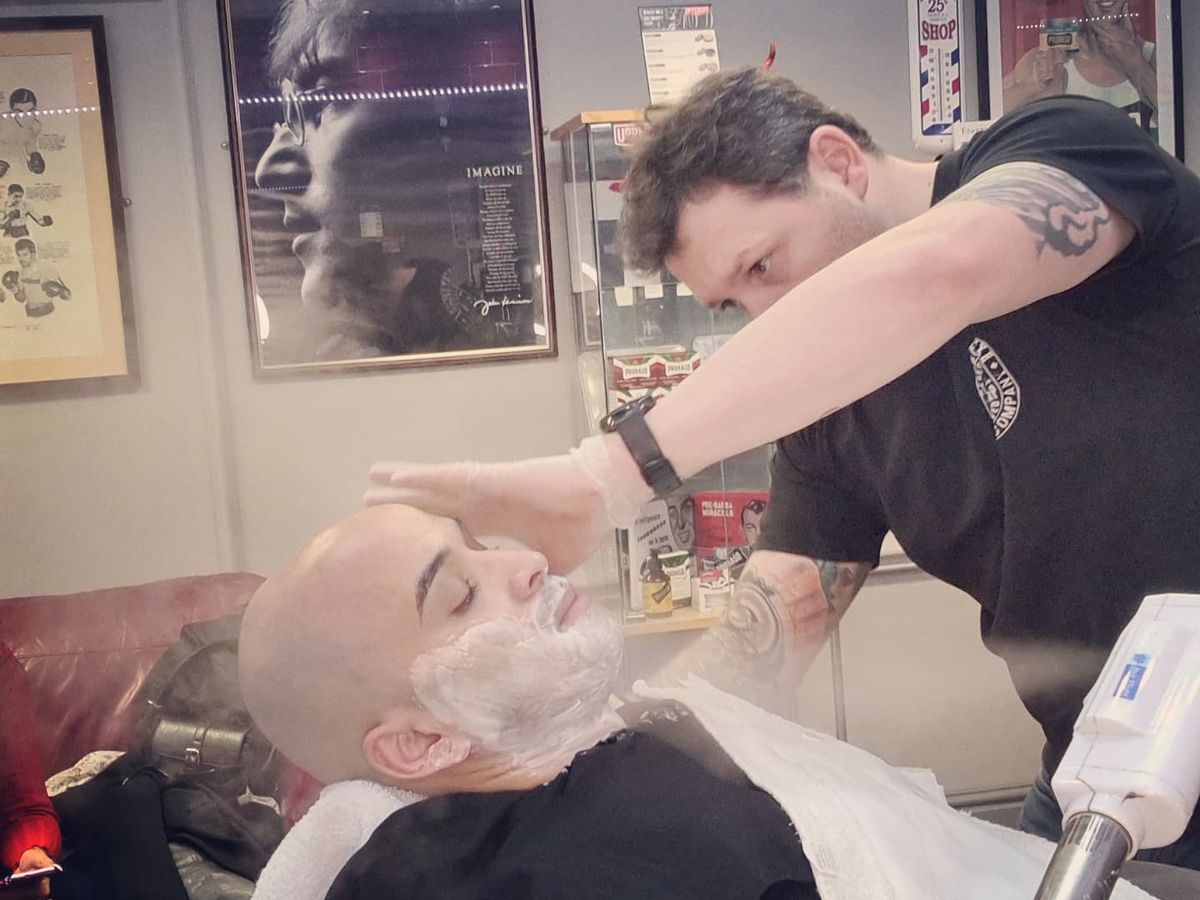 Dean giving a hot-towel shave in the shop